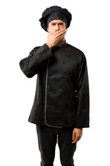 Chef man In black uniform covering mouth with hands for saying something inappropriate. Can not speak on isolated white background