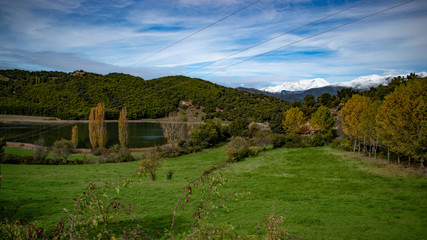 Natural landscape composed of snowy mountains and a lake inside.