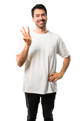 Young man with white shirt happy and counting three with fingers on isolated white background