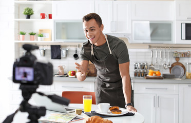 Food blogger recording video on camera in kitchen