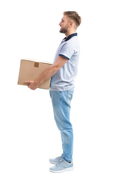 Full length portrait of young man carrying carton box on white background. Posture concept