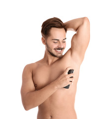 Young man using deodorant on white background