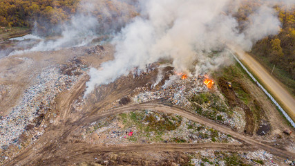 Aerial view of illegal landfill in the forest. Waste incineration, environmental issue, heavy junk...