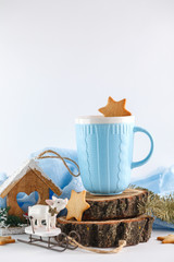 blue mug, ginger cookies and Christmas symbols on white background. New year's composition 2018