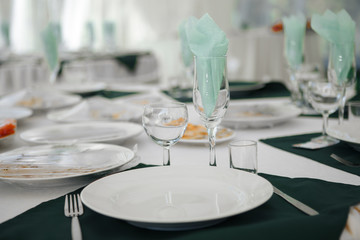 Dining table with crockery and Cutlery, close-up.