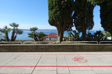 Fresh air and healthy activities background. Bicycle road along the sea.