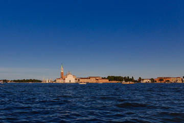 Naklejka premium San Giorgio Maggiore church and bell tower over water at sunset, in Venice, Italy
