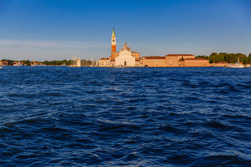 San Giorgio Maggiore church and bell tower over water at sunset, in Venice, Italy