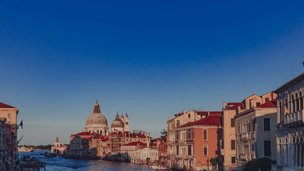 Obraz premium Basilica of Santa Maria della Salute and Venetian houses under blue sky at sunset, in Venice, Italy