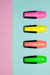 Multicolor felt tip pens on pastel pink and pastel blue background. Colorful markers