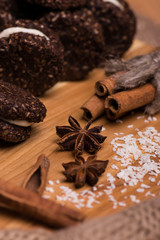 Cookies closeup. Chocolate cookies with nuts, cinnamon and cardamom on a wooden table.