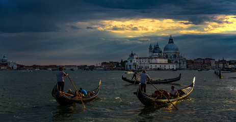 Italy beauty, before the storm gondolas near to cathedral Santa Maria della Salute in Venice, Venezia