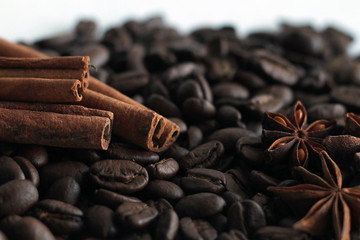 Coffee beans and cinnamon sticks isolated on white background.