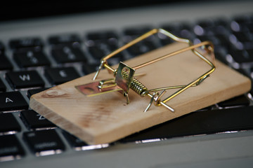 mousetrap on the keyboard of a computer