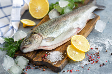 Preparation of trout, sliced lemon and green dill.