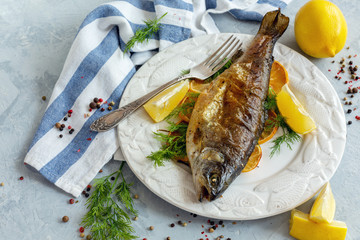 Baked lake trout with lemon and dill.