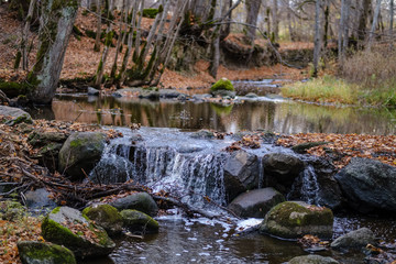 waterfall over the rocks in river stream in forest