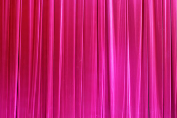 Photo Theatrical curtain of crimson color of velvet.