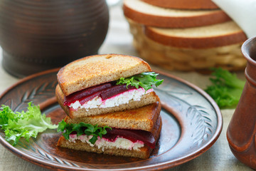 Beetroot, feta and lettuce sandwiches with rye bread. . Breakfast in rustic style. Selective focus