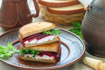 Beetroot, feta and lettuce sandwiches with rye bread. . Breakfast in rustic style. Selective focus