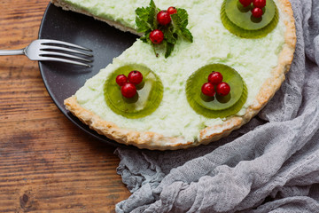 Freshly baked homemade berry pie with jelly on a wooden table