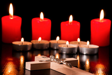 A crucifix against a background of lighted candles