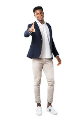 Full body of Handsome african american man wearing a jacket handshaking after good deal on white background