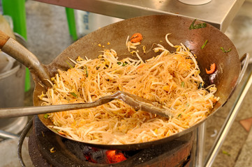 Thai chef is cooking fried nooddle that called Pad Thai