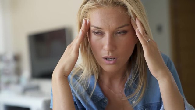 Young blond woman headache