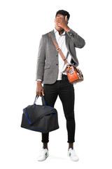 Full body of African american business man traveling with suitcases covering eyes by hands. Do not want to see something on white background