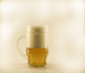 Glass mug with beer isolated on a white background