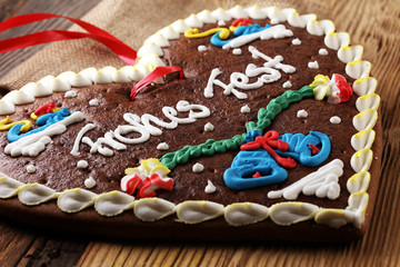 original bavarian christmas gingerbread heart on wood. xmas gingerbread cookie.