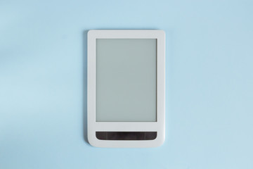 White tablet on a blue pastel background