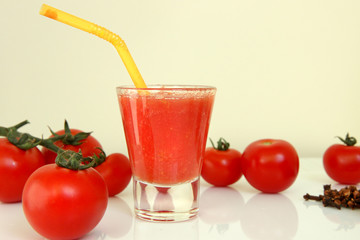 glass of tomato juice and fresh tomatoes isolated on white