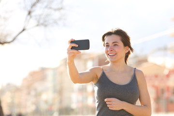 Happy woman recording video outdoors