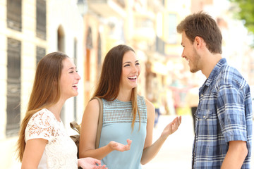 Three smiley friends talking in the street