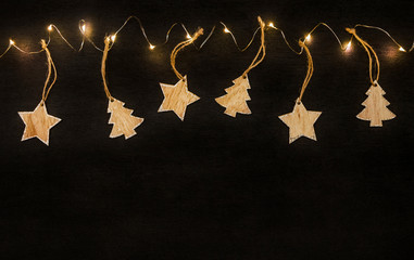 wooden stars and a Christmas tree on a black