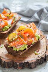 Danish open sandwich Smorrebrod with salmon on rye bread