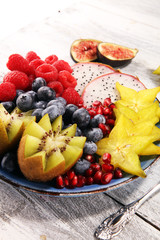 Fototapeta na wymiar fruit bowl. Bowl of healthy fresh fruit salad on rustic background