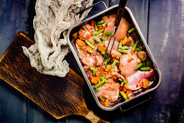Prepared for baking chicken meat with vegetables.