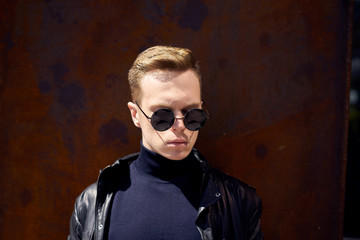 young handsome guy in the background is the rusty walls