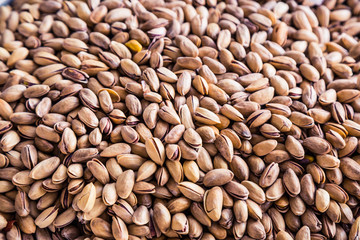 A mixture of nuts on the market. Various nuts in the store, juicy snacks sold in the market. Food for vegetarians. Ingredient for cooking and sweets. 