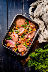 Prepared for baking chicken meat with vegetables.