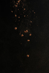 Cocoa powder explosion in motion. Chocolate dust on a black background. Food for food. Isolate,...