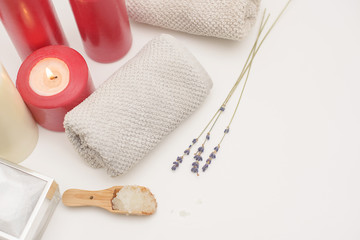 Spa care - candles, cream, towel. Flat lay, spa concept. 
