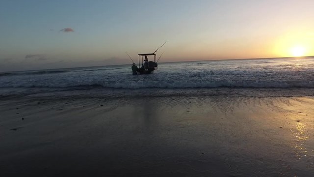 Fishing surfing boat at sunset at Playa Colorado beach on the coast of Nicaragua