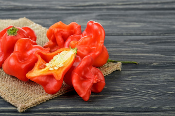 Ripe Chili Peppers on wooden background. Capsicum baccatum.