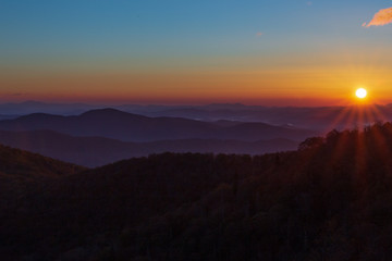 Sunrise on the Blue Ridge Parkway in Autumn with blue sky and hint of a cloud.