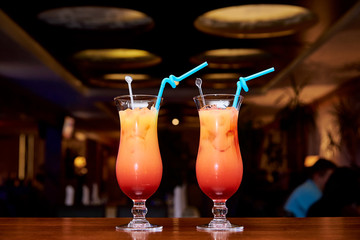 Bright cold cocktails on a dark background of the restaurant.