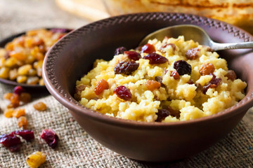 Sweet millet porridge with raisins and dried cranberries